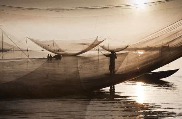 [Waterworlds]. Fishermen‘s work in the early hours across Vietnam. The work often starts in the night and lasts untill the next morning. Over several weeks I attended a few fishermen to observe their daily work and procedure of catching fish. Location: Hoi An, Vietnam. (Photo and caption by Kostas Maros/National Geographic Traveler Photo Contest)