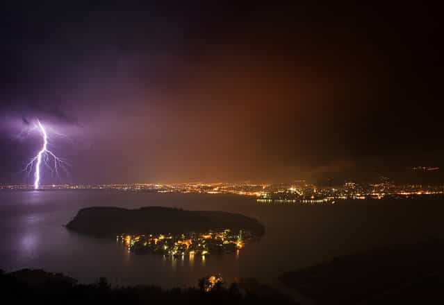 [Eerie lights]. In west Greece the town of Ioannina is vulnerable in rain even the summer. The electric atmosphere made me prepare for outdoor adventure in order to illustrate the town as a rainy electric town. I left my shutter open 30 sec waiting for the thunder over the lake. Location: Ioannina ,Greece. (Photo and caption by Panagiotis l/National Geographic Traveler Photo Contest)
