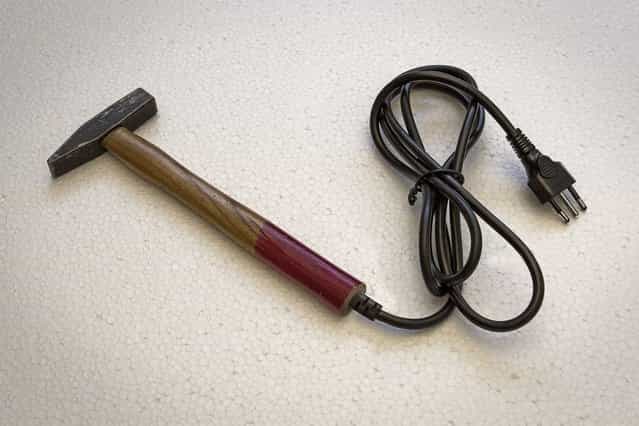 A hammer with an electric plug. (Photo by Giuseppe Colarusso/Caters News)
