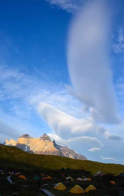 [Lasting Reach]. Towards the evening spectacular cloud formations stretched out above the Cuernos of Torres del Paine. The contrast between the power of Patagonia and the vulnerable tents once again establishes how nature can be so intriguing. Location: Torres del Paine National Park, Chile. (Photo and caption by Violette Wolters/National Geographic Traveler Photo Contest)