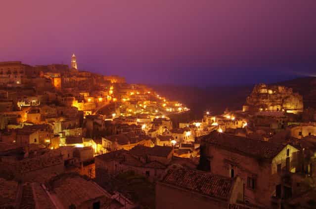 [Light up]. Dusky fog gently descending upon the ancient cave settlement of Sassi di Matera as the town lit up. Location: Matera, Basilicata, Italy (Photo and caption by Chen Fei/National Geographic Traveler Photo Contest)
