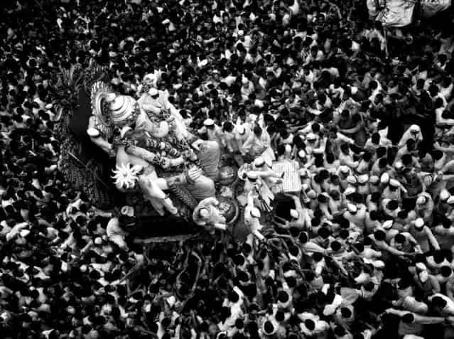 [Worship Frenzy]. It was the final day of Ganpati celebrations in 2011. Large processions of people took to the streets in celebration. Ganpati is one of the most worshiped Hindu deities. The average height of these idols is between 20 and 30 feet. Location: Mumbai, India. (Photo and caption by Girish Menon/National Geographic Traveler Photo Contest)