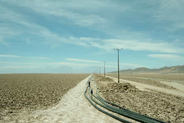 [Anthropization]. Tourists contemplate astonished the power lines and pipes that cross the desert to feed mining towns. Location: Atacama, Chile. (Photo and caption by Nicolas Sanchez/National Geographic Traveler Photo Contest)