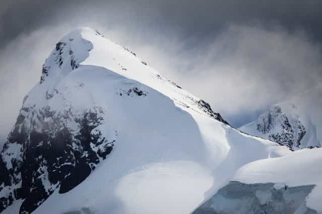 [Summit Attempt]. Mountain climbers in Antarctica struggle near the summit in overcast and threatening storm conditions. (Photo and caption by Joshua Holko/National Geographic Traveler Photo Contest)