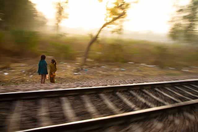 [Trackside Sisters]. Two young girls next to the railway tracks in Tamil Nadu, India. India's arterial-like network of tracks attracts trackside-dwellers across the entire subcontinent. (Photo and caption by Danny Pemberton/National Geographic Traveler Photo Contest)