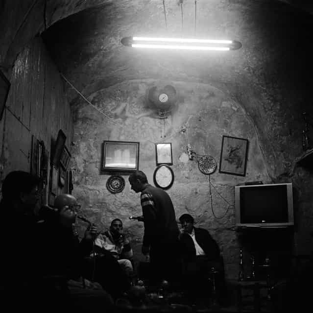 [Shisha Bar, Jerusalem, January 2012]. Palestinian men smoke water pipes in a shady den near Damascus Gate in Jerusalem's historical city center.Ronnie Niedermeyer (Photo and caption by /National Geographic Traveler Photo Contest)