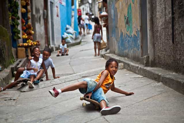 [Enjoying life]. These kids enjoyed free saturday by playing on narrow streets of favela Vidigal. They loved the camera and seeing themselves in pictures. We hade so much fun together! Location: Vidigal, Rio de Janeiro, Brazil. (Photo and caption by Anna Karatvuo/National Geographic Traveler Photo Contest)