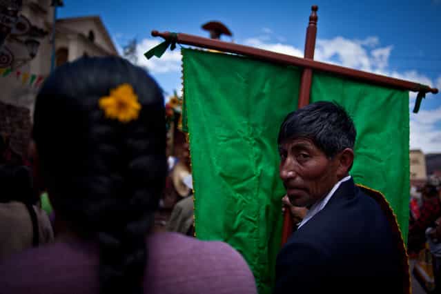[Looking Back]. Man looking back during a procession in a town outside of Cuzco, Peru. (Photo and caption by Justin Meredith/National Geographic Traveler Photo Contest)