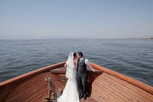 [I Do]. In the middle of the Sea of Galilee, there was a happy newly wedding couple having their love celebration on the boat. Location: Sea Of Galilee, Israel. (Photo and caption by Lydia Isnanto/National Geographic Traveler Photo Contest)