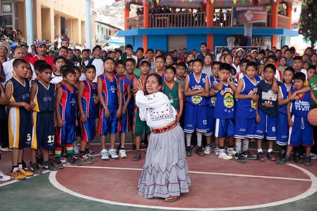[The opening basket]. Sofia Robles, Mayor of Santa Maria Tlahuitoltepec, shoots the opening basket to inaugurate the village tournament. Location: Santa Maria Tlahuitoltepec, Oaxaca, Mexico. (Photo and caption by Jorge Santiago/National Geographic Traveler Photo Contest)