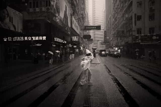 [Chick dropped in soup]. No, not chicken soup..... It's a literal translation of a Chinese expression for being drenched （落湯雞）。 Caught this well dressed lady trying to cross the street in a torrential down pour. Location: Hong Kong. (Photo and caption by Brian Yen/National Geographic Traveler Photo Contest)