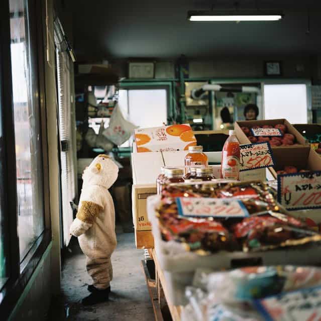 [Little Cleaner]. This photo was taken at a market during my trip to Hokkaido which is located at the north of Japan. House cleaning with all members of the family at the end of a year is a popular custom in Japan.On this day,the last day of the year,I found a little cleaner there. A child of this store was trying hard to wipe a condensation at the window with a glass wiper when I happened to visit there. I heard a tiny voice inside his heart, [mmm... I wish I was taller...] This is a scene to symbolize a Japanese New Year's Eve so it has made my heart warm. (Photo and caption by Miki Kudo/National Geographic Traveler Photo Contest)