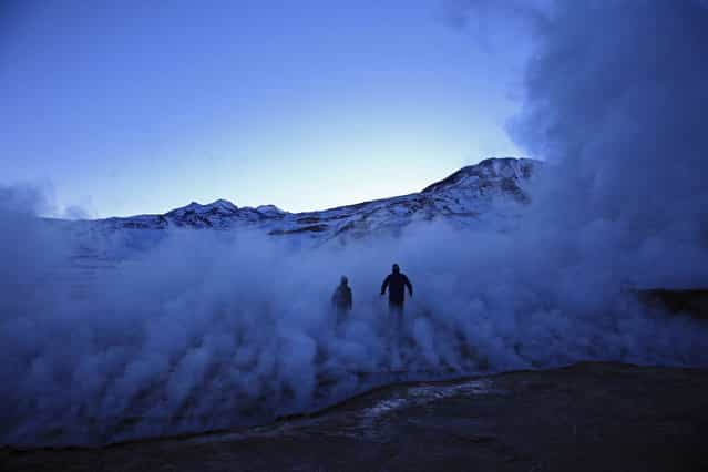 [Experiencing]. Silhouettes of father and his son walking through the steam coming for Geysers el Tatio in North Chile. (Photo and caption by Magdalena Rakita/National Geographic Traveler Photo Contest)