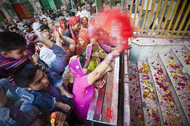 [Celebrates Holi]. Holi is a religious spring festival celebrated by Hindus. Holi is also known as Festival of Colours. It is celebrated by people throwing scented powder. Location: Mathura, India. (Photo and caption by Ng Hock How/National Geographic Traveler Photo Contest)