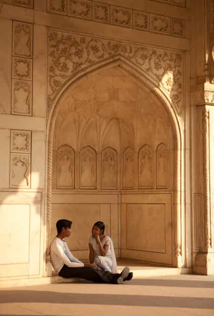 [A Guardian Watches Over The Lovers]. Late in the afternoon the light was just right. The pillars created a guardian shaped figure as if watching over the two lovers as they remained entranced in each others company. Location: Agra, India. (Photo and caption by Sam Hawley/National Geographic Traveler Photo Contest)