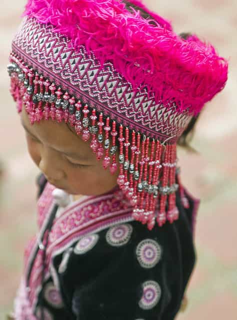 [Her Name is Flower]. Flower is a girl from the Hill Tribes of northern Thailand who, wearing her native costume, comes to Doi Suthep temple, just above Chiang Mai, Thailand, to greet visitors. (Photo and caption by Ileana Oroza/National Geographic Traveler Photo Contest)