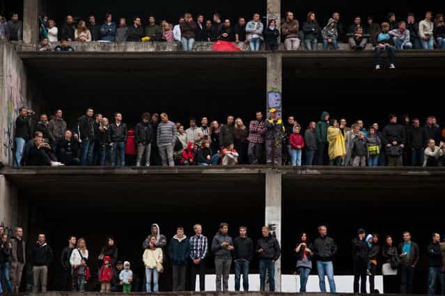 [Viewers]. People watching car racing event from abandoned building balconies. Curiosity to see Formula 1 race for the first time in Lithuania was bigger then the risk standing on the edge of the building ment to be demolished. By now it is destroyed. (Photo and caption by Ruta Balciunaite/National Geographic Traveler Photo Contest)