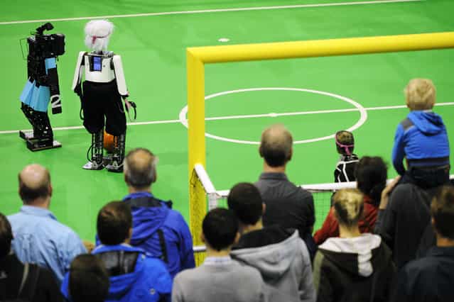 lota of spectators during finals Soccer Humanoid Teen size (NimbRo / Germany (hairy robot) vs CIT Brains) at the World Championship finals of RoboCup 2013 in Eindhoven (NL). (Photo by Bart van Overbeeke)