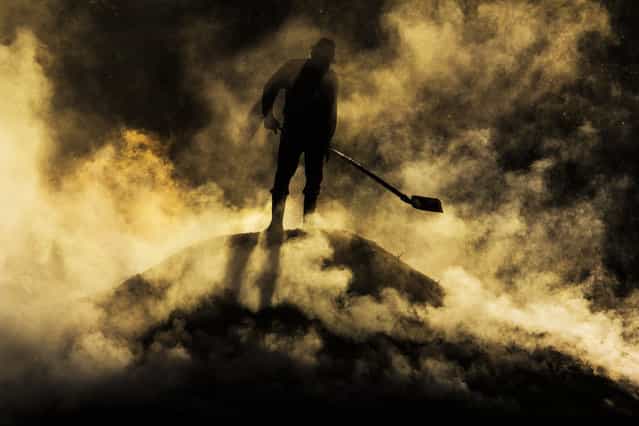 [Out from Hell]. 6:00 am, near Biertan village, in Transylvania, worker preparing charcoal. Location: Romania. (Photo and caption by Razvan Teodoreanu/National Geographic Traveler Photo Contest)