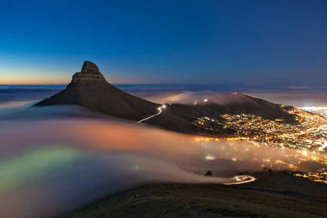 [Cape Town Fog]. Taken one evening in April 2013 this long-exposure image shows a bank of fog rolling off the Atlantic Ocean, over Kloof Nek & Signal Hill and into the city of Cape Town, South Africa. (Photo and caption by Eric Nathan/National Geographic Traveler Photo Contest)