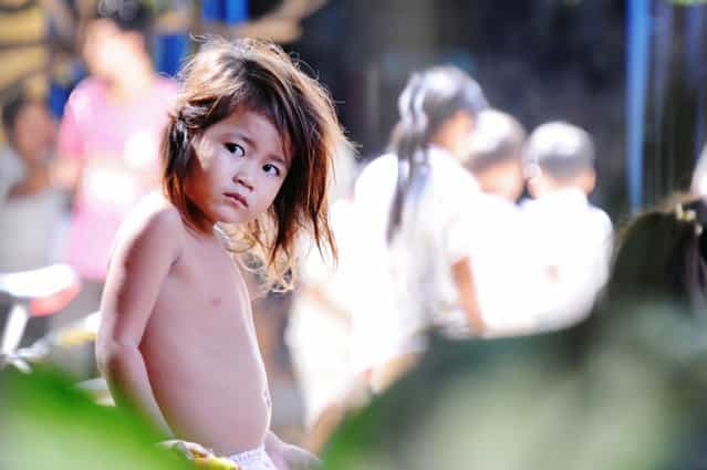[Girl's gaze]. I captured this photo in Phnom Penh, Cambodia in October 2011. I am intrigued by the intensity of this little girl's gaze. (Photo and caption by Sandra Tavares/National Geographic Traveler Photo Contest)