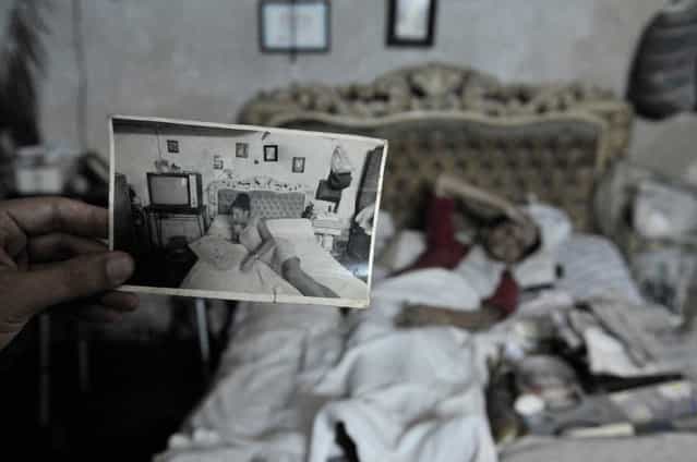 [Looking Back in Time]. While walking down the street in Old Havana, I was invited into this elderly woman's home. She was lying in bed and told me she wasn't feeling well. She asked if I had any aspirin which I did have in my purse. As I bent over to give it to her, I noticed this photograph on the nightstand beside her bed. It was taken of her many years before lying in the very same bed. I thought this was very cool. (Photo and caption by Terri Gross/National Geographic Traveler Photo Contest)
