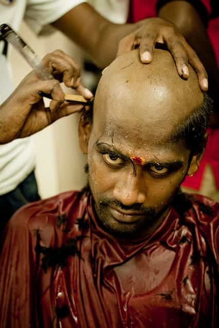 [The great determination]. The Thaipusam devotees would shave their heads (chaulam) during the Thaipusam before their spiritual journey to fulfil vows and as a symbol of humility and penance. I choose to portrait this honest moment during hair shaving to etch out his inner heart and high level of spiritual commitment towards his fulfillment of his vows to the Lord from his eyes. His eyes demonstrated the spiritual energy, courage and willpower, the confidence to undertake any work or fulfil any dream. Location: Batu Caves, Malaysia. (Photo and caption by Yew Kiat Soh/National Geographic Traveler Photo Contest)