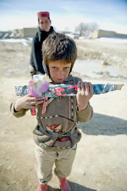 [Afghan Boy With Wooden Rifle]. Future friend or foe? Location: Paktika Province, Afghanistan. (Photo and caption by Alex Manne/National Geographic Traveler Photo Contest)