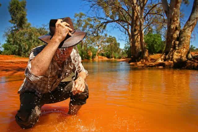 [Wet]. A swollen creek bed in the desert near Broken Hill in Australia a local cools off. (Photo and caption by Miles Rowland/National Geographic Traveler Photo Contest)