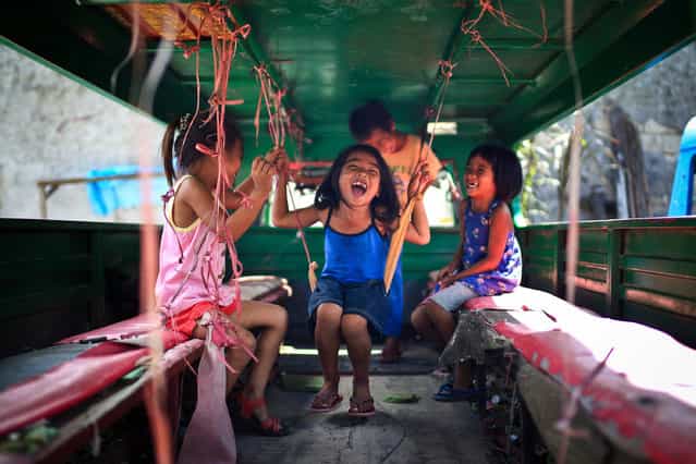 [Joyful]. Kids are enjoying themselves inside a Jeepney. Their smiles make me feel peaceful and joyful. I think this should be the pure happiness for them. Location: Cebu City, Philippines. (Photo and caption by Mac Kwan/National Geographic Traveler Photo Contest)