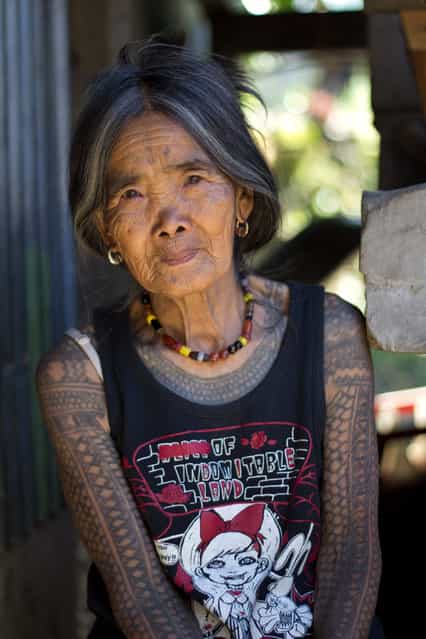 [The Last Kalinga Tattoo Artist]. A fascinating culture of the Igorot people brought me and my girlfriend to Kalinga. Head-hunting ceased decades ago, however, the motifs of Kalinga tattoos and the way they are being tattoed remains the same (charcoal and an orange thorn). We decided to visit this beautiful tribeswoman who is the last Kalinga tattoo artist. After a few days, long hours spent on buses and jeepneys, we were lucky to find a local guide Francis who brought us to Buscalan. We were overwhelmed how hospitable and friendly she is. Her natural beauty and her tattoo tempted me to ask her for a pose outside her dwelling. Location: Buscalan village, Kalinga, North Luzon, Philippines. (Photo and caption by Michal Duchek/National Geographic Traveler Photo Contest)