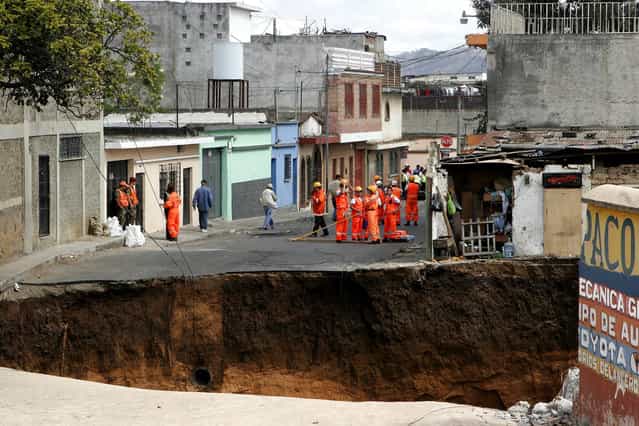 A hole remains where a structure once stood in Guatemala City, on February 23, 2007. A giant sinkhole swallowed several homes killing at least three people, officials said. (Photo by Moises Castillo/AP Photo via The Atlantic)