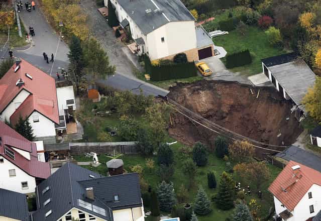 A large crater that appeared in the early hours in the German town of Schmalkalden, on November 1, 2010. (Photo by Alex Domanski/Reuters via The Atlantic)