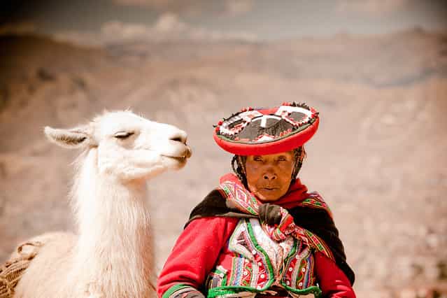 [A Peruvian Woman and her Lama]. I LOVE when people look like their pets. This Peruvian Woman was trying to make money by posing for tourists with her pet Llama at Sacsayhuamán, Ruins, Cusco, Peru. (Photo and caption by Laura Grier/National Geographic Traveler Photo Contest)
