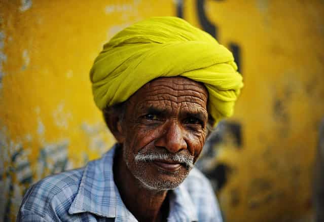 [Portrait of man in a citron green turban]. Rajasthan is widely recognized for its charming and elegant colourful turbans. I saw this Local man sitting on the street, he wearing a citron green turban, the colour blended into background painted wall. I thought it's nice, took this shot. Location: Udaipur, Rajasthan, India. (Photo and caption by Xuesong Liao/National Geographic Traveler Photo Contest)