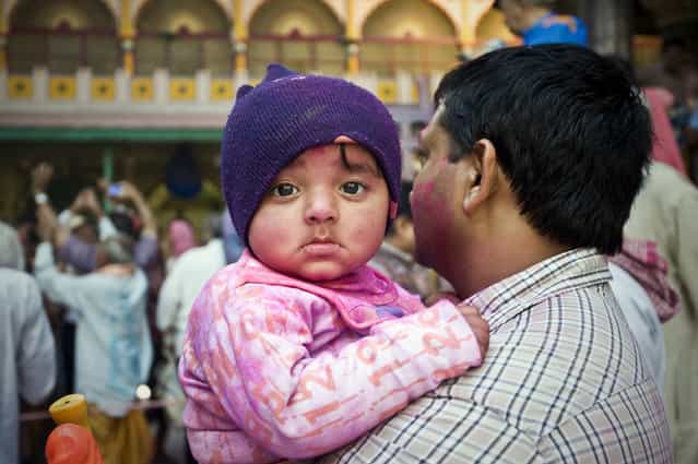 [The Toddler]. When I was taking photos of the people celebrating Holi Festival, I noticed this toddler was looking at me for a while. Location: Mathura, India. (Photo and caption by Ng Hock How/National Geographic Traveler Photo Contest)
