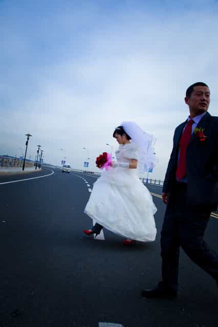 [Bride Crossing]. Newlyweds cross the street to get to their reception. You have to move fast with everything in China. (Photo and caption by Jeffery Boggan/National Geographic Traveler Photo Contest)