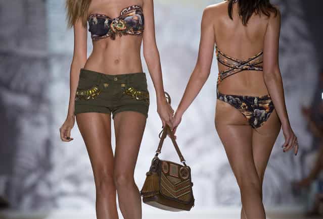 In this Friday, July 19, 2013 photo, models walk the runway during the Agua Bendita show at the Mercedes-Benz Fashion Week Swim show in Miami Beach, Fla. (Photo by J. Pat Carter/AP Photo)