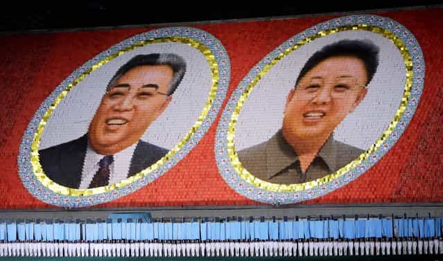 North Korean students use different colored cardboard to form portraits of late North Korean leaders Kim Jong-il and Kim Il-sung (L) as background during a mass gymnastic and artistic performance [Arirang], in Pyongyang July 26, 2013, as part of celebrations ahead of the 60th anniversary of the signing of a truce in the 1950-1953 Korean War. (Photo by Jason Lee/Reuters)