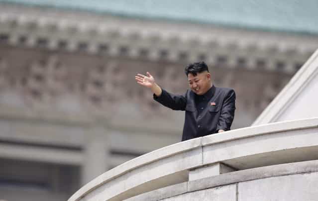 North Korean leader Kim Jong-un waves to the people during a parade to commemorate the 60th anniversary of the signing of a truce in the 1950-1953 Korean War, at Kim Il-sung Square in Pyongyang July 27, 2013. (Photo by Jason Lee/Reuters)