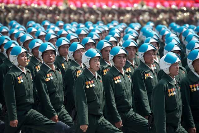 North Korean soldiers march during a military parade past Kim Il-Sung square marking the 60th anniversary of the Korean war armistice in Pyongyang on July 27, 2013. North Korea mounted its largest ever military parade on July 27 to mark the 60th anniversary of the armistice that ended fighting in the Korean War, displaying its long-range missiles at a ceremony presided over by leader Kim Jong-Un. (Photo by Ed Jones/AFP Photo)