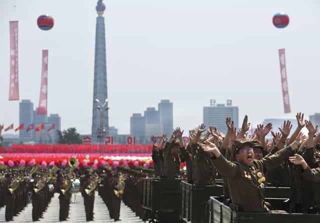 North Korean military veterans wave to their leader Kim Jong Un during a mass military parade on Kim Il Sung Square in Pyongyang to mark the 60th anniversary of the Korean War armistice Saturday, July 27, 2013. (Photo by David Guttenfelder/AP Photo)