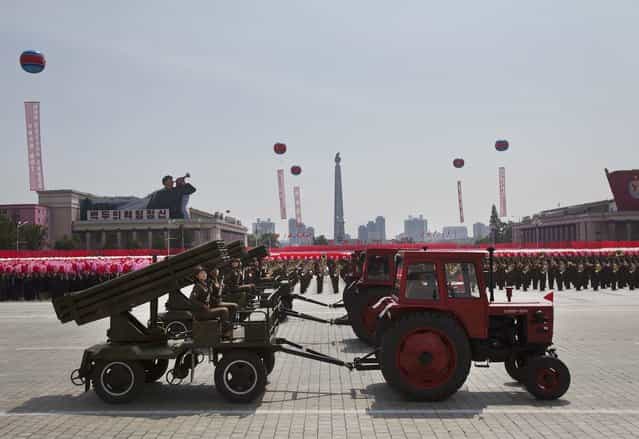 Tractors pull weapons on wagons at a mass military parade on Kim Il Sung Square in Pyongyang to mark the 60th anniversary of the Korean War armistice Saturday, July 27, 2013. (Photo by David Guttenfelder/AP Photo)