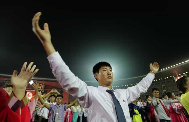 Young North Koreans gesture and cheer after a celebration to commemorate the 60th anniversary of the signing of a truce in the 1950-1953 Korean War, at Kim Il-sung Stadium in Pyongyang July 28, 2013. (Photo by Jason Lee/Reuters)