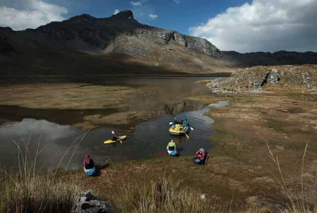 August 17, 2012 – Alpamarca, Peru – Raft and white water kayaks of the Amazon Express expedition set across Lago Acucocha after searching for the dry season source of the Amazon River. (Photo by Erich Schlegel/zReportage via ZUMA Press)