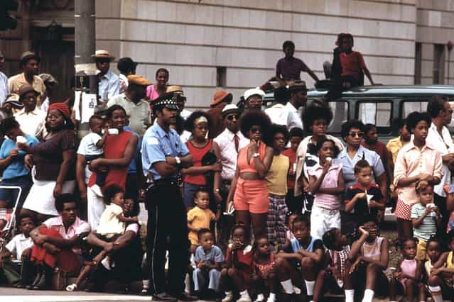 Members of Chicago's South Side community line a portion of Dr. Martin L. King Jr. Drive to watch the Bud Billiken Day Parade, August 1973. Hundreds of thousands turn out to watch and take part in the annual event. Bud Billiken Day started in 1929, to provide African-American youth living on the South Side a moment in the spotlight, a day each year to showcase their talents. (Photo by John H. White/NARA via The Atlantic)