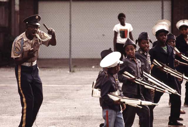 The Kadats of America, a young drill team, perform on a Sunday afternoon at a community talent show on the South Side. The leader, Major General Acklin, is shown giving commands to the youngsters, July 1973. (Photo by John H. White/NARA via The Atlantic)