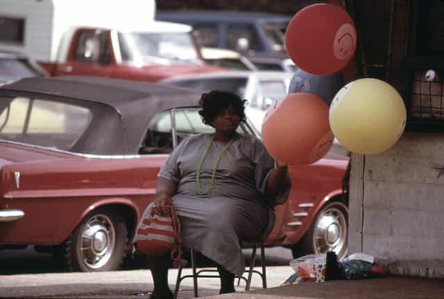 Woman selling [Have A Nice Day] balloons on a Chicago South Side street corner at Sox Park Baseball Field, June 1973. (Photo by John H. White/NARA via The Atlantic)