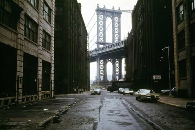 Manhattan Bridge tower in Brooklyn, New York City, framed through nearby buildings, in June of 1974. (Photo by Danny Lyon/National Archives and Records Administration via The Atlantic)