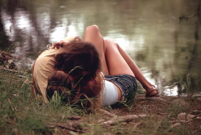 A teenage couple embraces on the bank of the Frio Canyon River near Leakey, May 1973. (Photo by Marc St. Gil/NARA via The Atlantic)
